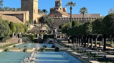 Gardens of the Alcázar de los Reyes Cristianos with pools, fountains, and sculpted cypress trees