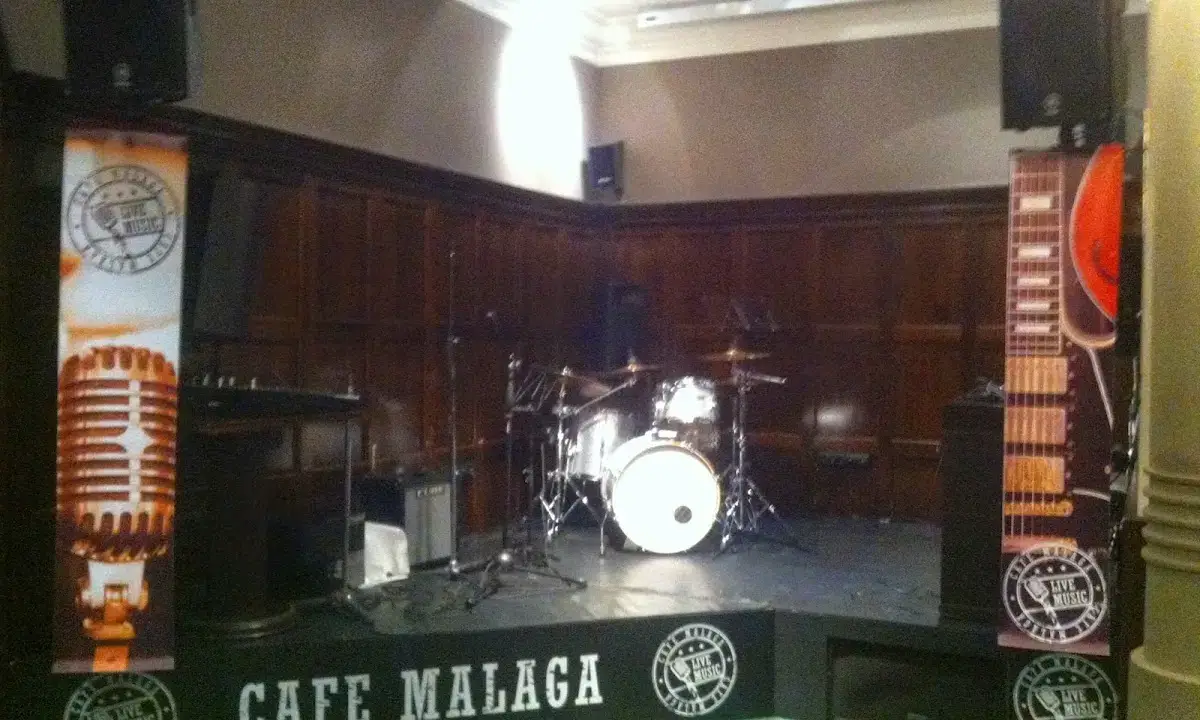 Intimate interior of Café Málaga with small live music stage and elegant modern décor