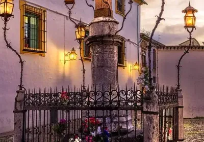 Cristo de los Faroles illuminated at night on the Plaza de Capuchinos