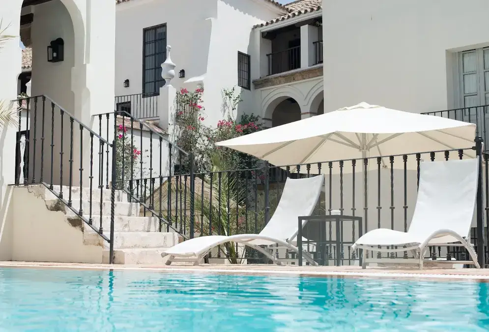 Andalusian patio of Las Casas de la Judería with arcades and fountain