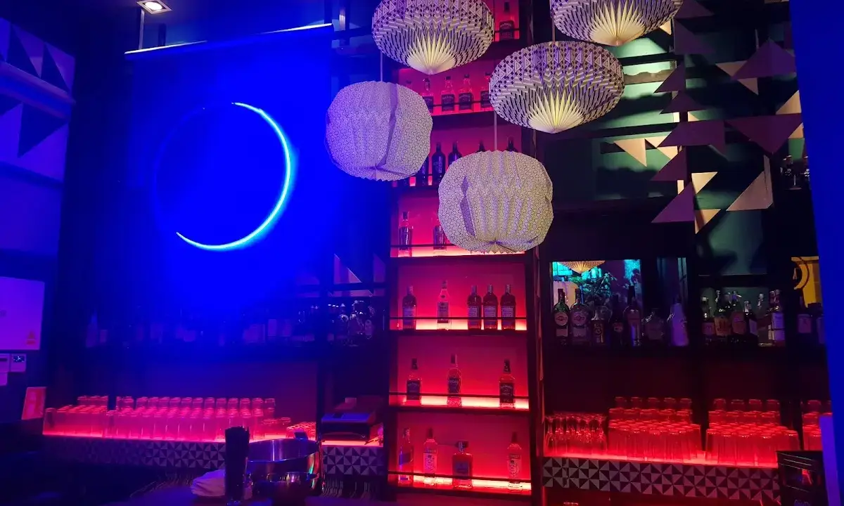 Lively interior of Pub Glam with colorful decorations and a diverse crowd